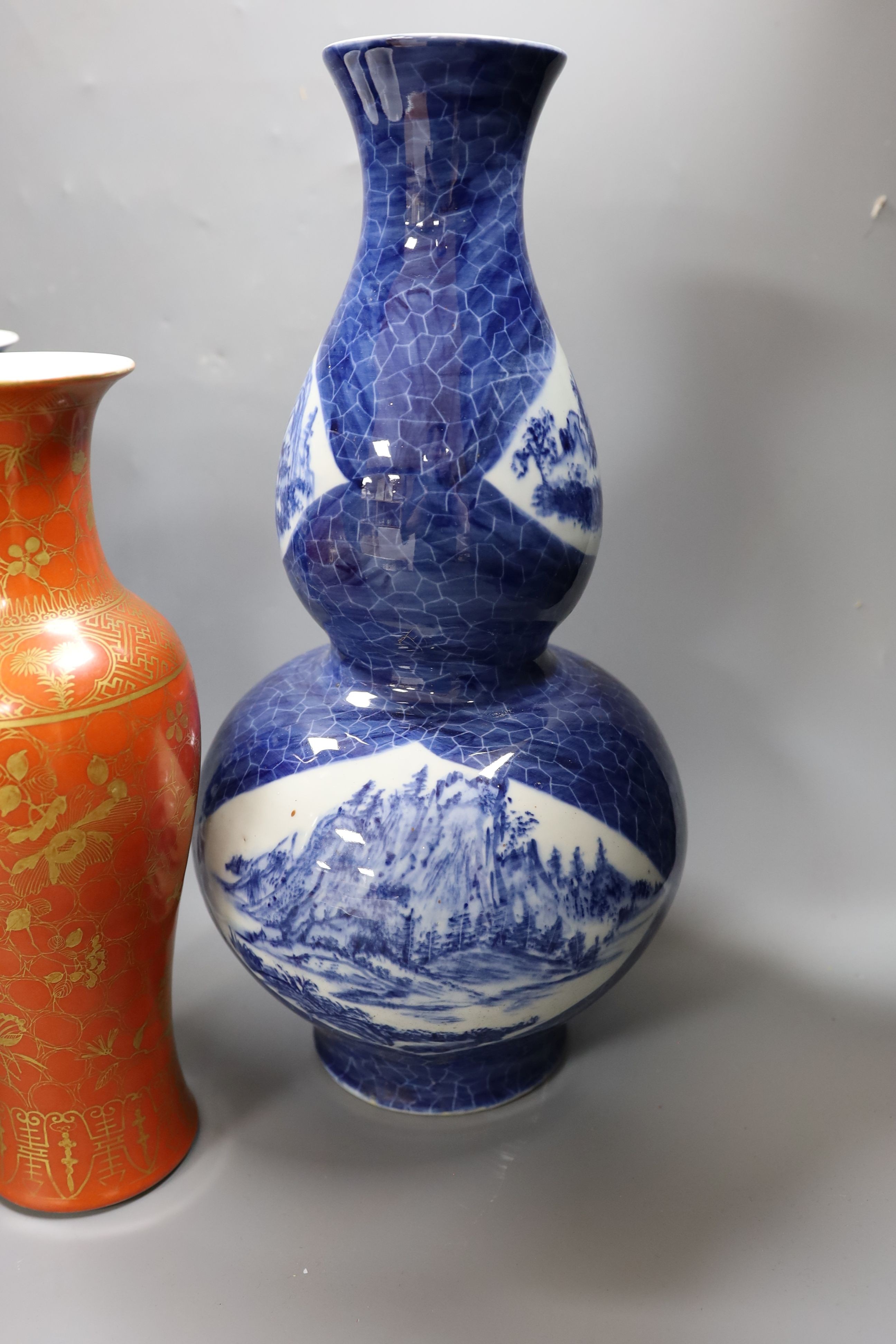 A Chinese blue and white gourd vase with landscape decoration, a similar blue and white sleeve vase and a Japanese Kutani vase